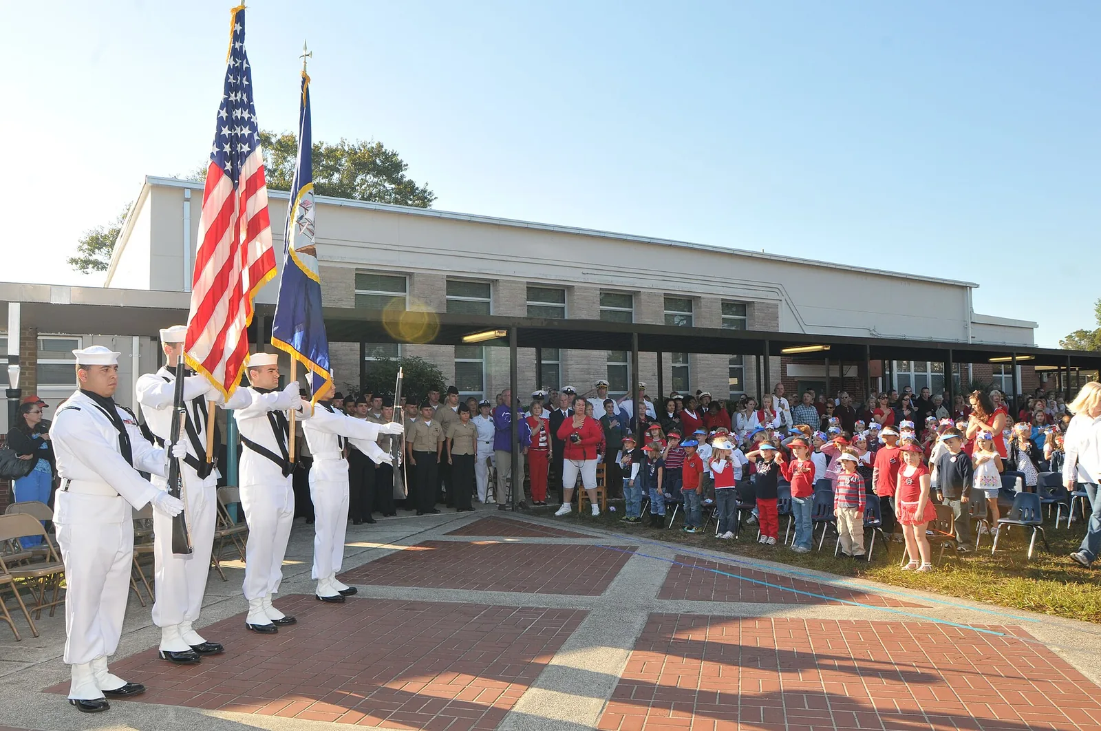 A Naval Station Mayport color guard presents the colors at a Veterans Day ceremony at a Jacksonville, Florida, elementary school.